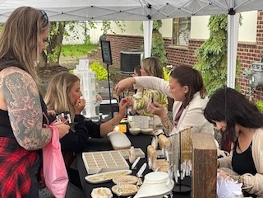 The Token Jewelry booth offered custom forever jewelry on-site, adding a personal touch for guests at the Broadway Boutique Fashion Show.
