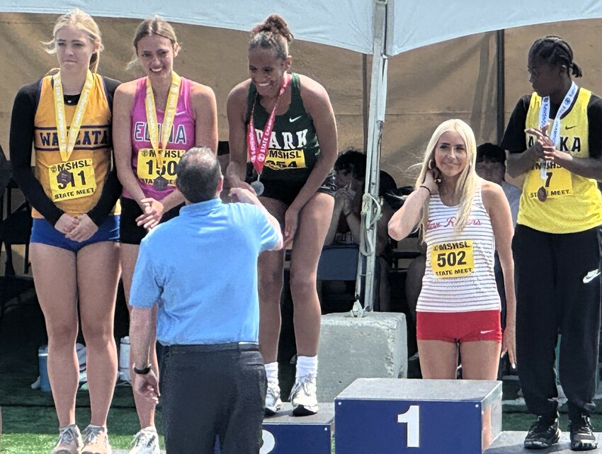 Rainna Jameson accepts her second-place medal in the girls' high jump after jumping 5-6 at state.