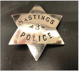 The badge pictured here is believed to be that of Albert Jacobson. Jacobson was one of the first three police officers for the City of Hastings. He was killed by a burglary suspect in July of 1894. Photo courtesy of the City of Hastings.