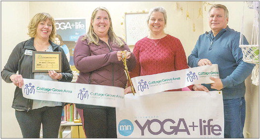 Laurie Levine, Amy Zellmer, Evonne Christensen of Gotham Tax Service and Troy Lund of Ensure gathered for the Cottage Grove Chamber ribbon cutting ceremony for the office of MN YOGA + Life Magazine. Photo by Bruce Karnick