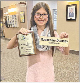 Mackenzie Delaney with her “Mayor for a Day” plaque and nameplate. Photo by Dan Solovitz