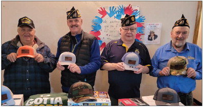 Local veterans Bob Wanish, Bruce Wozniak, Ed Staib, and Tony Goettl prepare care packages recently. Submitted photo.
