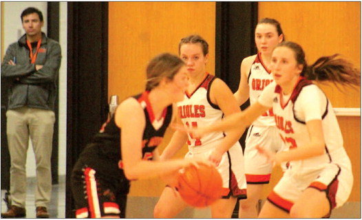 Mallory Eslinger, Kayte Licht, and Lily Hoel face off with Elk Mound as Nick Mahr watches the game from the south door.