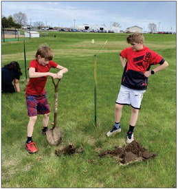 Prescott students, under the direction of STEM teacher Karey Sizemore, plant trees on the school campus as part of the Arbor Day Foundation’s Tree Campus K-12 program. Photos courtesy of Andrea Herzan
