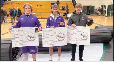 (From left): Louie Jahnke, Carson Wright and William Penn of the Ellsworth wrestling team hold up their medals and respective weight class brackets after winning their individual Middle Border Conference wrestling championships. Jahnke won the 182-pound bracket, Wright won the 106-pound bracket and Penn secured the victory in the 126-pound bracket. Photo courtesy of Ellsworth Panthers Wrestling