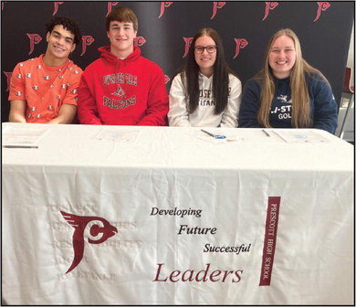 (From left): Aiden Russell, Jack Olson, Ariana Temmers, and Liz Rohl, sit together as they sign their letters of intent to play collegiate athletics at the next level. Russell will play football at Northern State University, Olson will play football at the University of Wisconsin-River Falls, Temmers will play softball at the University of Wisconsin-Oshkosh, and Rohl will play golf at the University of Wisconsin-Stout. Photo by Reagan Hoverman