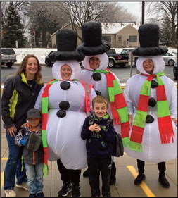Three Ellsworth Elementary crossing guards dressed up as snowwomen Friday, Dec. 2 and greeted students in the frosty air. Pictured are Mrs. Meyer, Mrs. Murphy and Mrs. Van Watermeulen with the Waller family.