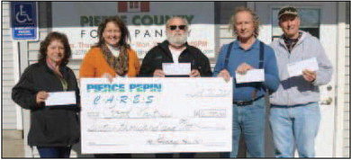 PPCS employee Barb Bee (second from left) presented food pantry representatives (from left) Heidi Albarado, Pierce County; Pete French, Prescott; Bob Huebel, Elmwood; and Jim Musgrave, Plum City with their checks from Pierce Pepin Cares. Each facility received a check for $2,000 with a total gift to area food shelves of $16,000. Photo courtesy of PPCS