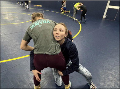 River Falls’ Jenna Lawrence practices against Assistant Coach Alisha Howk. Lawrence is the lone female wrestler for the Wildcats and the first-ever female in school history to qualify for the WIAA State Tournament. Photo by Greg Peters