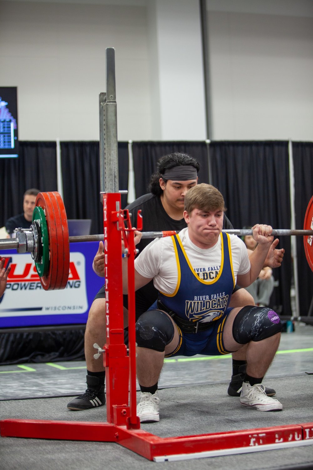 One of nearly 70 River Falls High School students involved with the powerlifting team gets parallel during a squat repetition in a meet earlier this season.