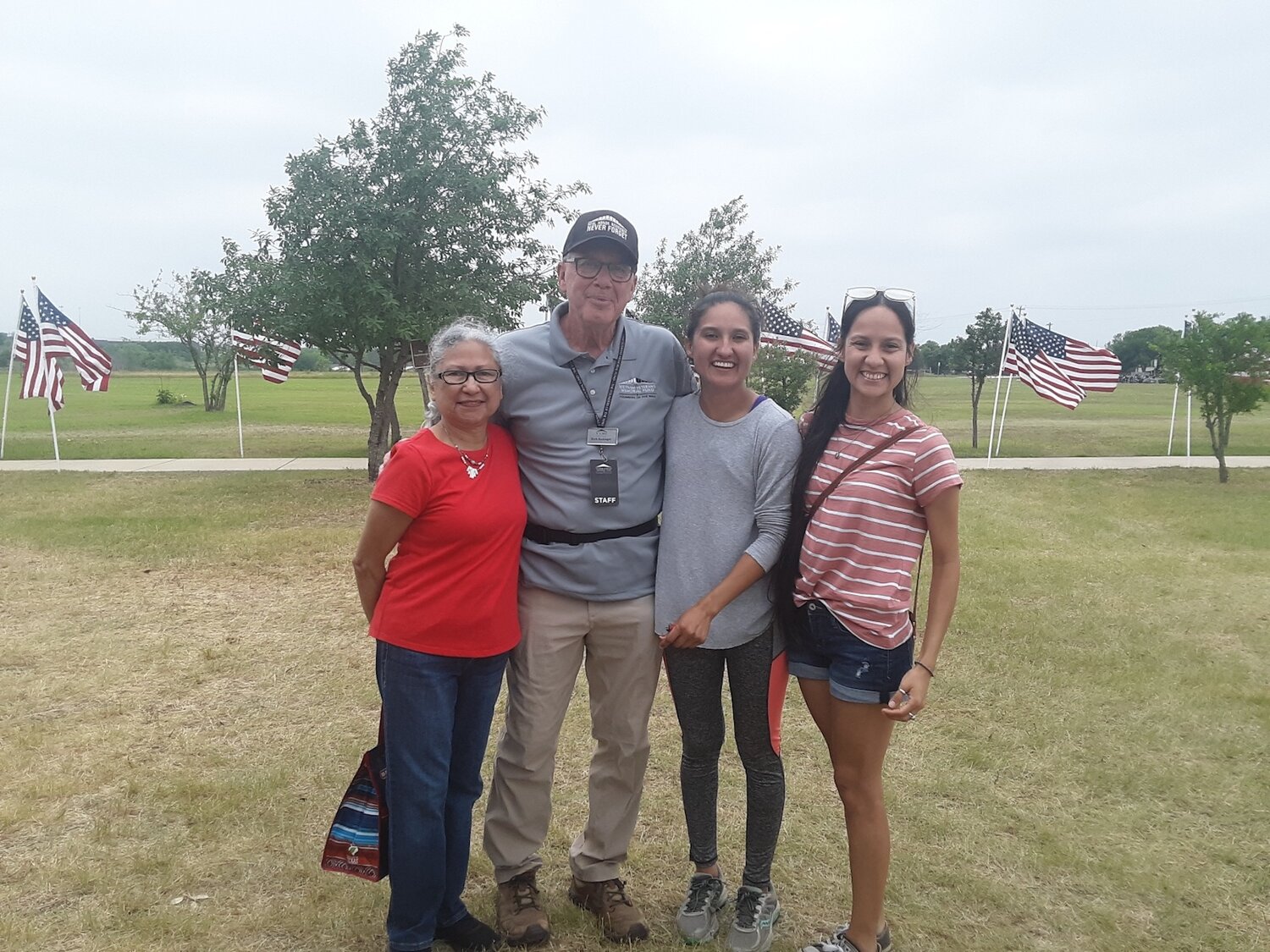 Herb Reckinger with fellow volunteers and visitors to a wall display in Kyle, Texas. The girls worked as volunteers at the wall with Reckinger, bringing their grandma when it was time to take the display down.