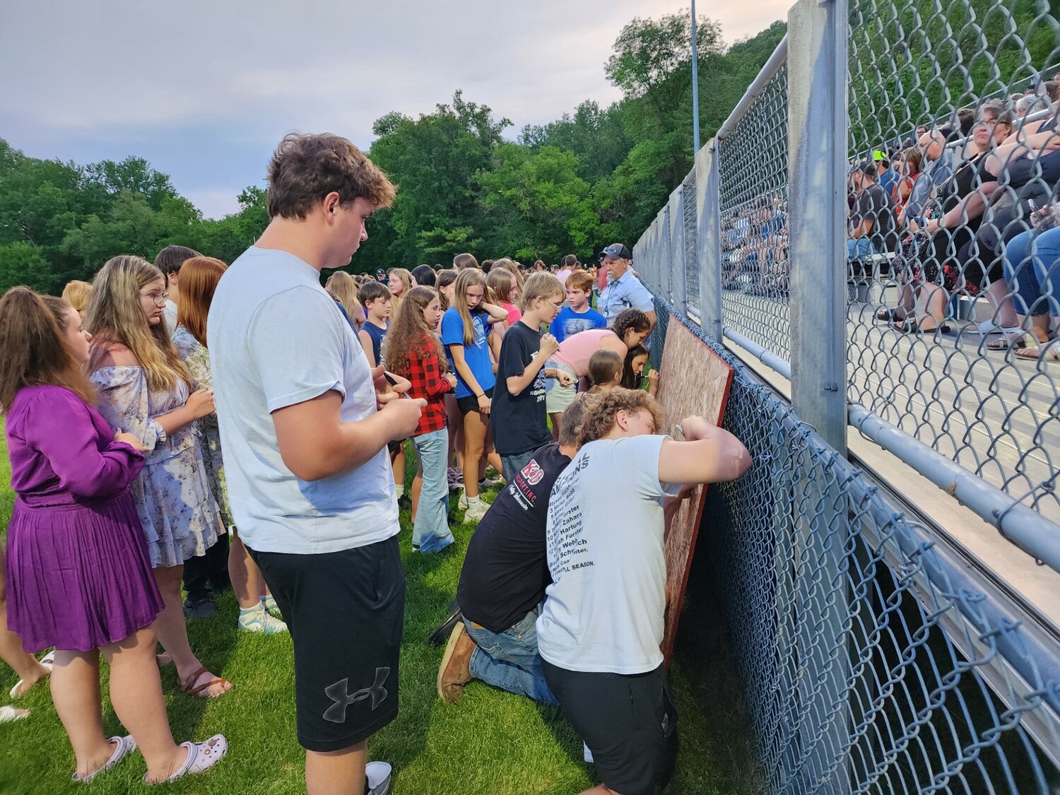 Community members signed prayer boards for the Loga and Bleskacek families on Wednesday, June 1 at a prayer vigil.