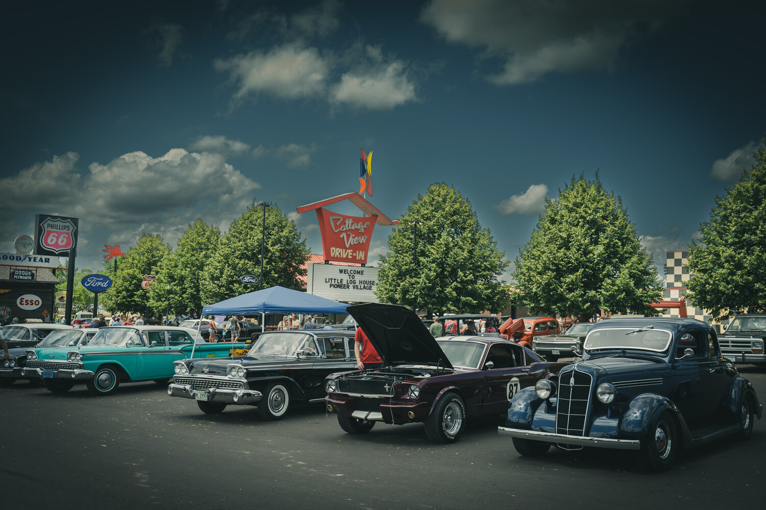 The antique car show is a huge attraction for Little Log House event guests and the slew of antique service signs plus the old Cottage View Drive-In sign takes visitors back in time.