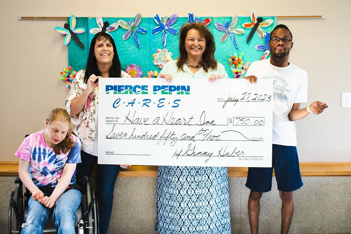 Have a Heart was awarded $1,000 to purchase materials for crafting, gardening, baking, and science experiments for its clients. Pictured (from left) are Morgan H.; Kelly Zillmer, Have a Heart executive director; Barb Bee, PPCS Senior Accountant, and Alonzo E.
