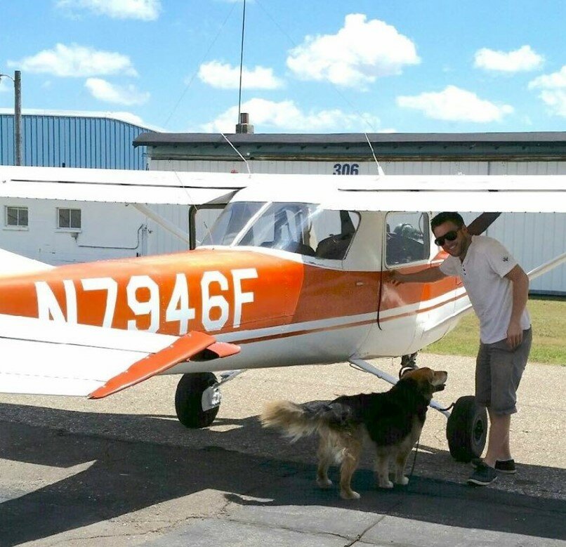 New Pierce County Journal sports reporter Joe Peine with his airplane and his dog. Peine has his pilot’s license.