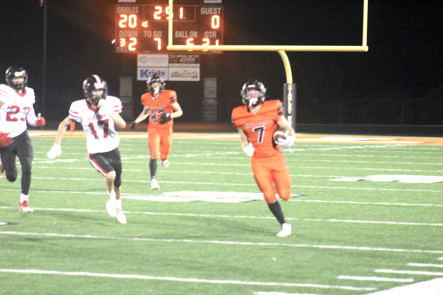 Landon Karlen (7) heads downfield on a 94-yard touchdown as Marathon attempts to stop the Oriole momentum Friday. To the back is Rudy Kletsch (83) who later scored his own touchdown.
