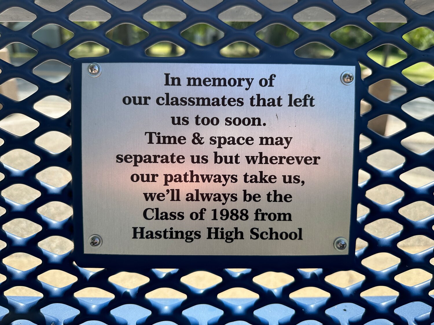 The plaque reads: “In memory of our classmates that left us too soon. Time & space may separate us but wherever our pathways take us, we’ll always be from the Class of 1988 from Hastings High School.”