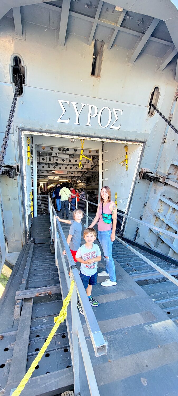 Megan Wenzel with her sons stand in the of the historic LST 325 ship.