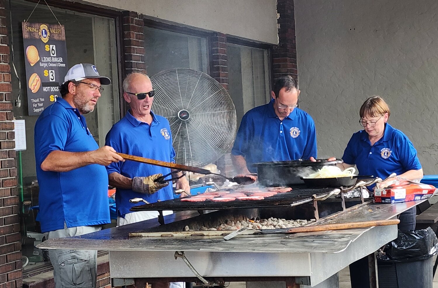 The Spring Valley Lions Club members grill up their “world-famous” burgers at last year’s Dam Days celebration.