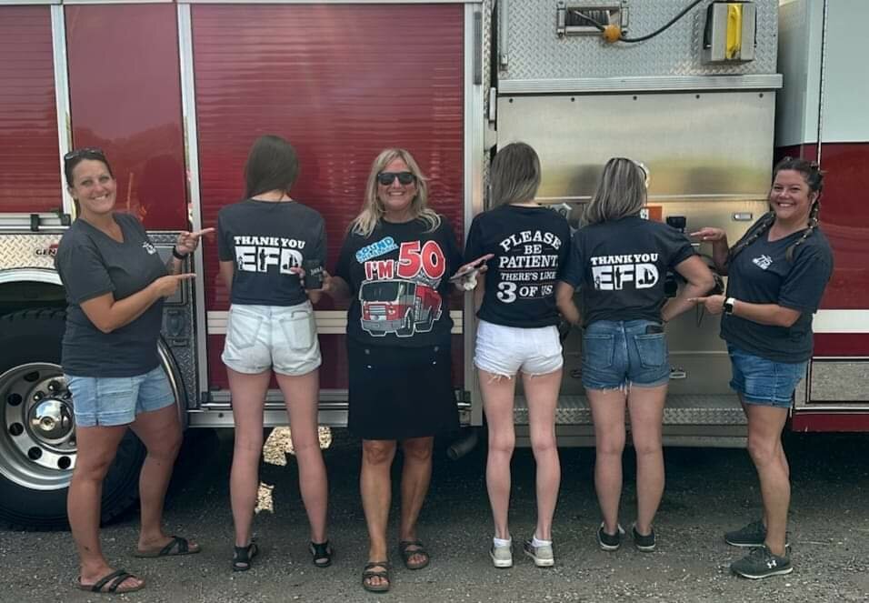 (From left): 715 employees Tessa Langer, Cassidy Quinton, Melissa Ryden, Emily Miller, Billie Jo Huppert and Abbie Flynn sport their T-shirts worn at the Ellsworth Fire Department fundraiser Aug. 25.
