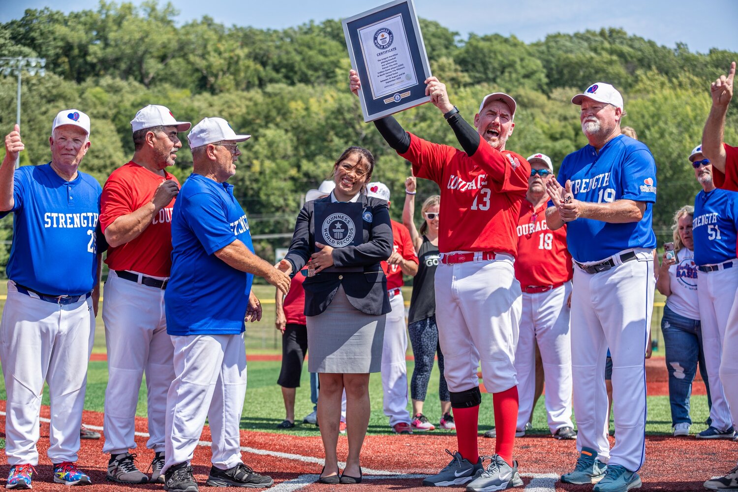 The Endless Game board members accepted the certificate from the Guinness Adjudicator for their world record longest marathon baseball game in Kansas City surrounded by family, friends, volunteers and fellow players.  Left to right: Bill Hutton, Jessie Aguirre, Jerry Weaver, World Record adjudicator Natalia Ramirez Talero, Soctt Reinardy and Ron Humble.