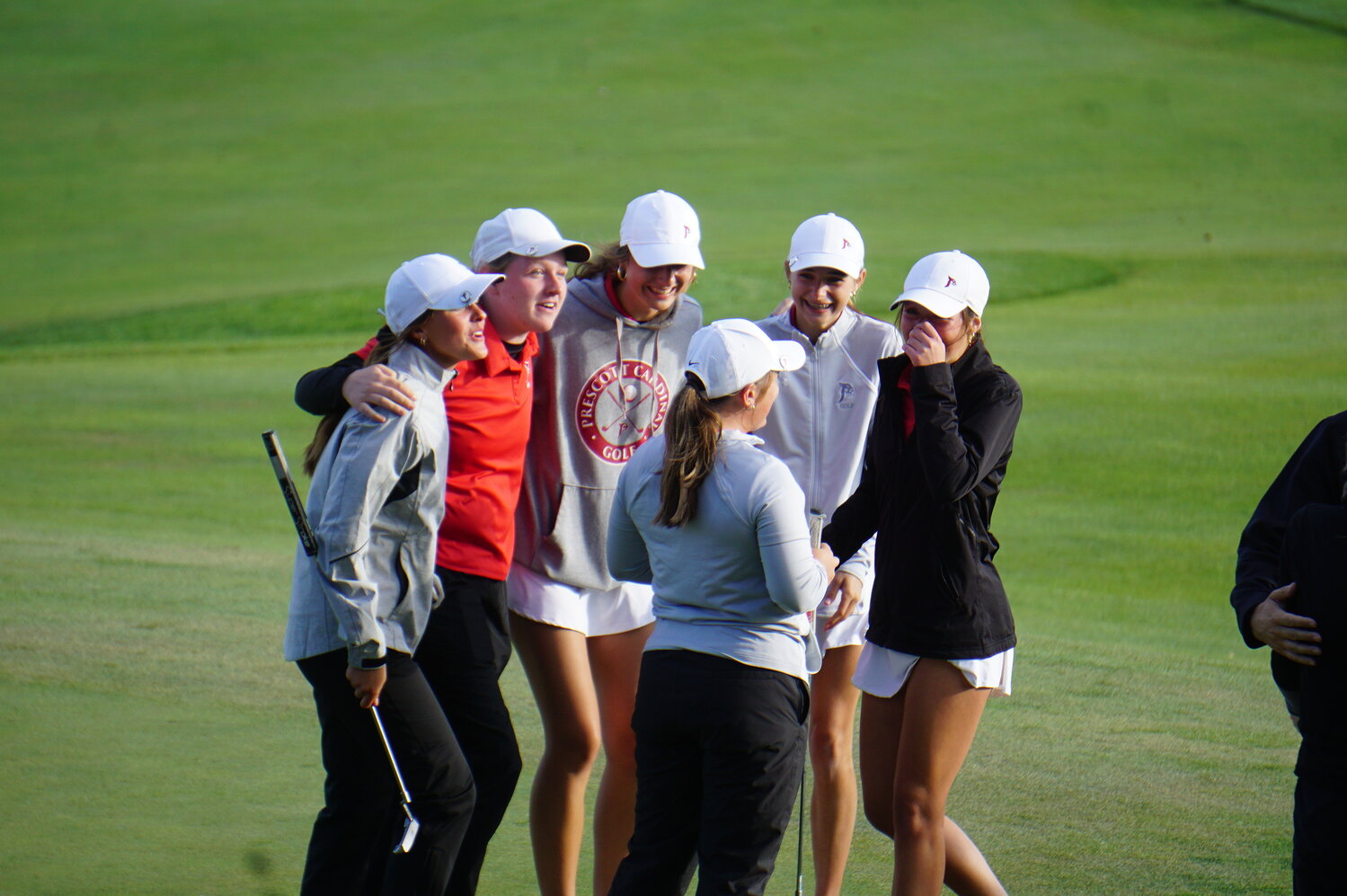 The Prescott Cardinals stormed back on their second nine Tuesday afternoon to win their fourth consecutive Division 4 State Championship Tuesday at University Ridge in Madison. At far left, Gabby Matzek watched her long putt on the last hall roll in to ice the victory. At left, the state squad celebrated their win on the green - Jeanne Rohl, Gabby Matzek, Lydia Feran, Macy Reiter, Layla Salay and Anika Fredericks.