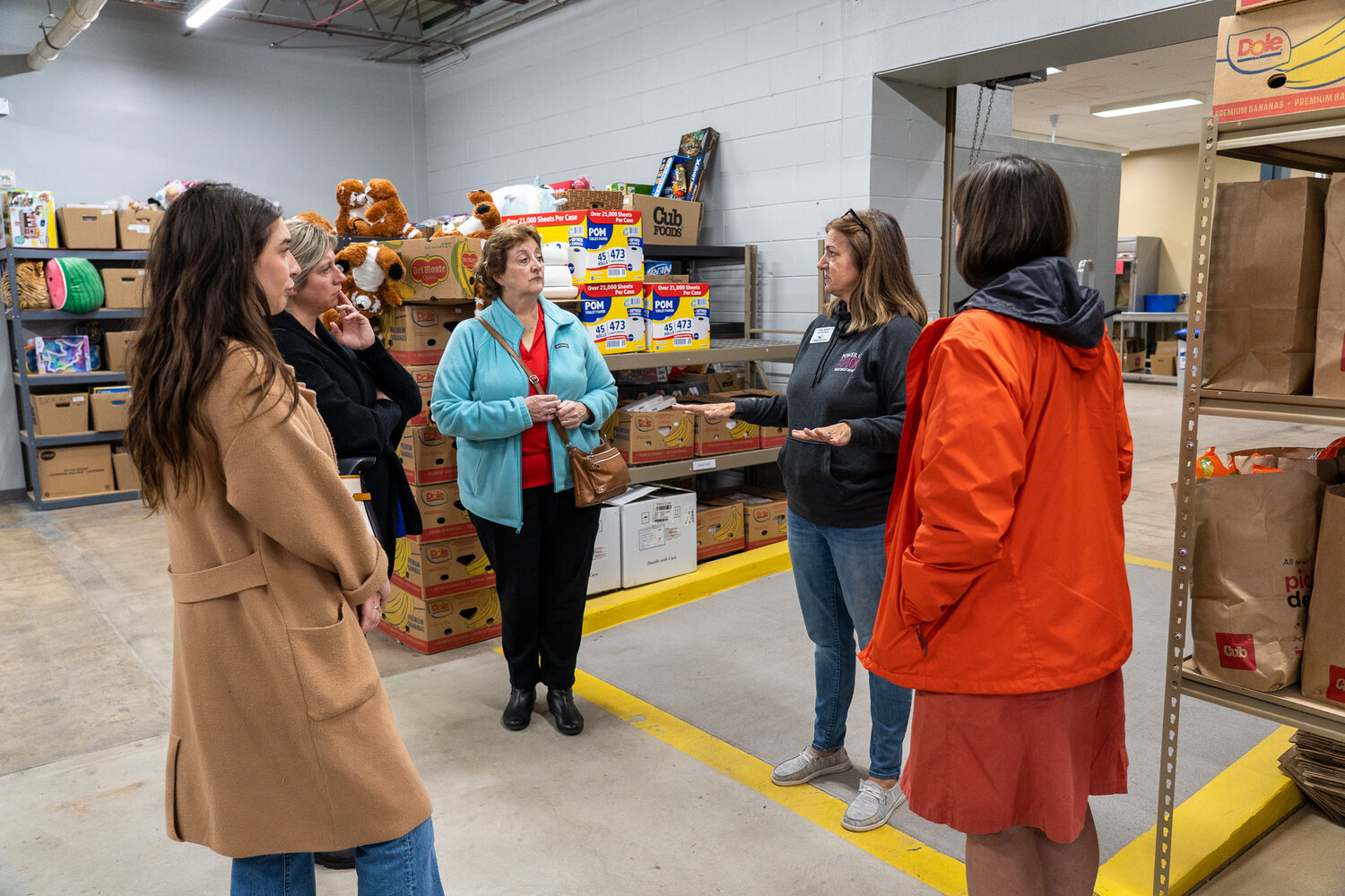Part of the group received a tour of the expanded storage and sorting area at Hastings Family Service. L to R Jayme Harlander, Christina Taylor-Haley, Janet Bremer, Amy Sutton and Tara Tommes.