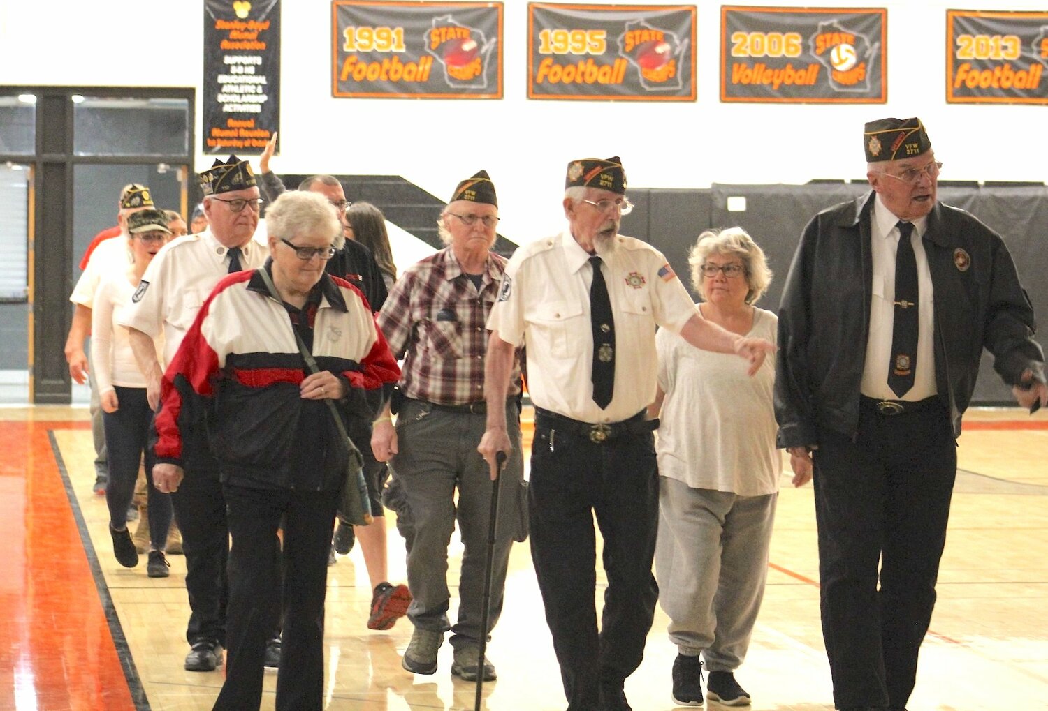 Legion and VFW members and their spouses enter the Stanley-Boyd gymnasium during the Veterans Day Event Friday, Nov. 10. Shown above from right to left are Art Osvold, Anna Toms, John Saunders, Gary Toms, Pat Osvold, Ed Staib, and Amber Broughton.