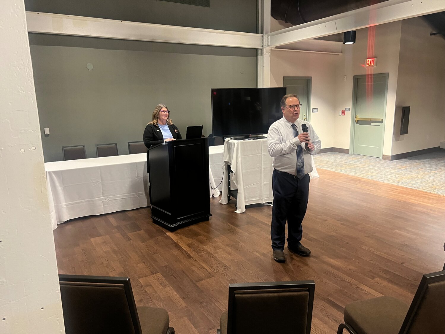 Community Development Director John Hinzman and Mayor Mary Fasbender spoke at the onset of a ceremony celebrating completion of The Confluence on the riverfront in downtown Hastings Thursday night.