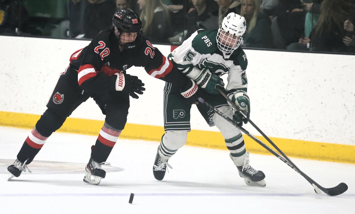 Park sophomore forward Gavin Sand fights to get to the puck before a Stillwater opponent.