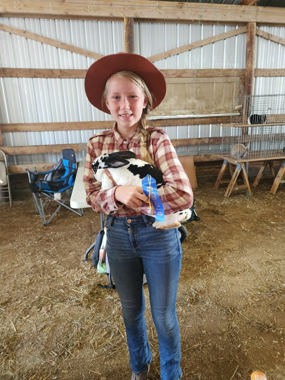 Jubilee Yeager, of the Martell Rushers, shows off her bunny Birchie after rabbit judging at the Pierce County Fair Tuesday, Aug. 6.