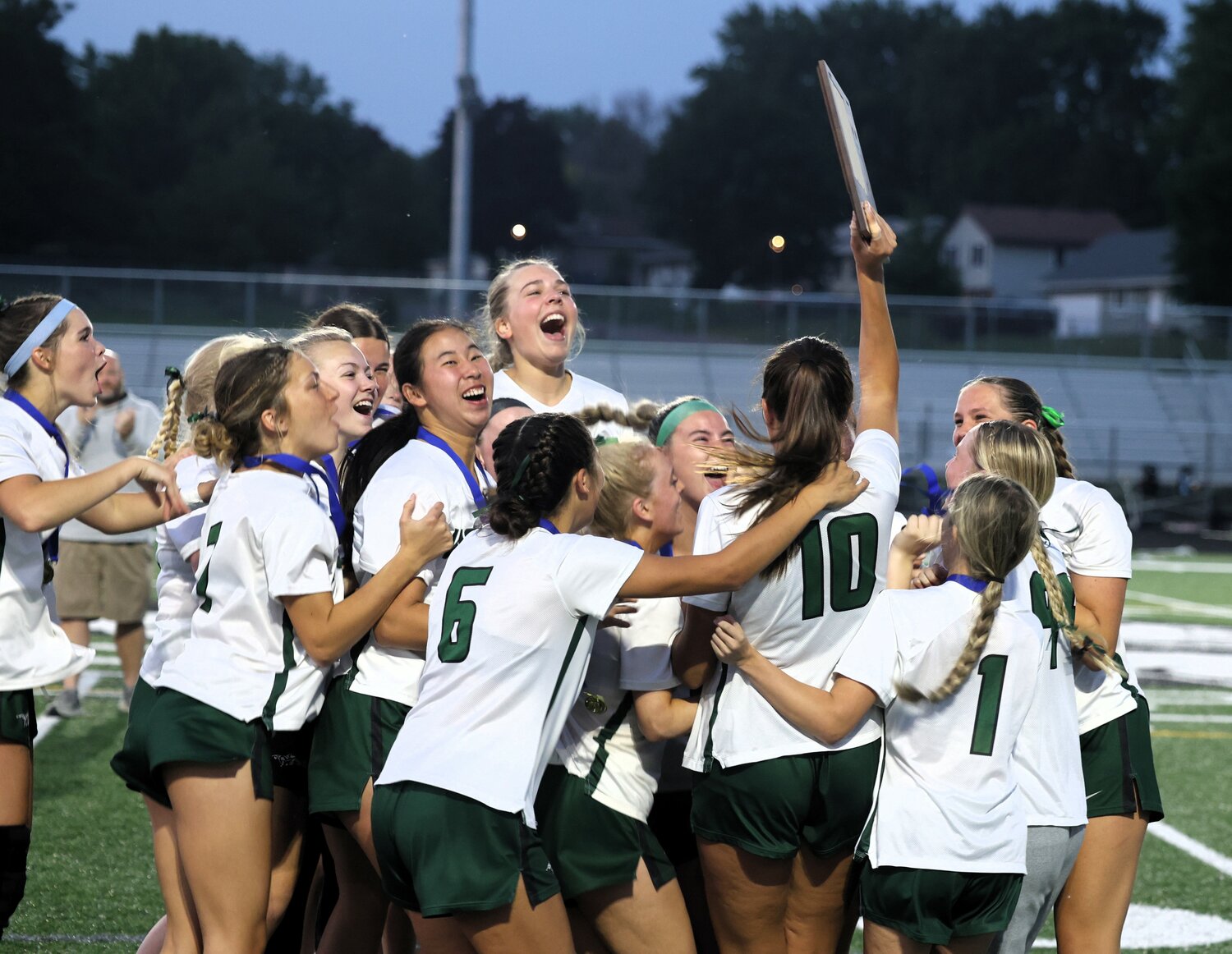 Park's players celebrate a wild 11-10 win in triple overtime against Cretin-Durham Hall in the section finals Wednesday.