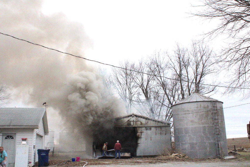 Smoke is billowing from a barn fire on Coach Rd. as Kansas Fire Chief Kirk Allen knocks down the flames.