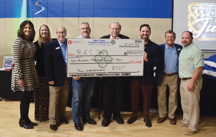Members of the Edgar County Community Foundation and the REC Center board proudly display a $100,000 check. Pictured from left to right are Megan Carroll, REC Center executive director Erin Hutchison, ECCF development manager Warren Sperry, Scott Ingrum, REC Center Board vice president and Capital Campaign co-chair Steve Benefiel, REC Board president and Capital Campaign co-chair Drew Griffin, ECCF board president Bob Morris and Don Bartos.