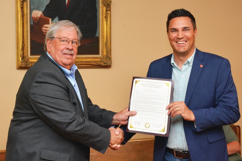 Edgar County Board Chairman Jeff Voigt, left, accepts an Illinois House of Representatives resolution congratulating the county on its bicentennial. Rep. Adam Niemerg (R-Dietrich), right, made the presentation, during the county board meeting Wednesday, June 14.