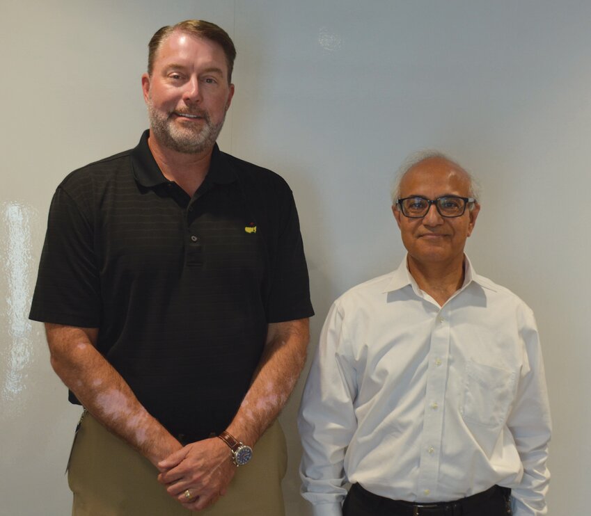 Chad Thompson, left, and Kishore Ahuja, right, pose for a photo after a Tuesday, June 19 PEDCO meeting. Ahuja, the president and COO of North American Lighting, attended the meeting to network with other local business leaders and discuss the needs of the community.