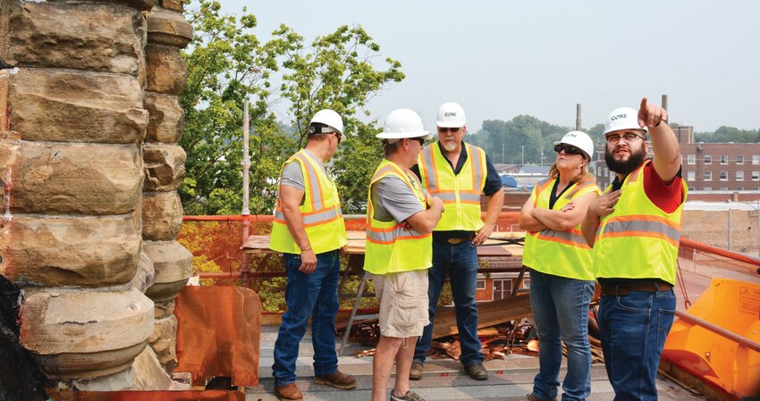 Harrison Meece, project manager for CORE Construction Management, points out problems encountered to Edgar County officials during a tour of the roof work on the Edgar County Courthouse. Left to right, Edgar County Sheriff Jeff Wood, county board members Andy Patrick, Russ Lawton, Lisa Ellis and Meece.