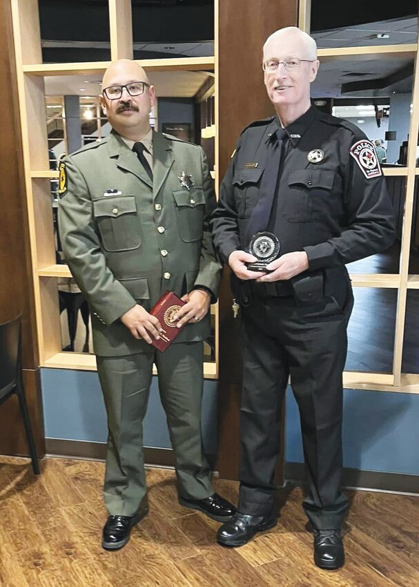 Illinois State PoliceTrooper Kris Martinez, left, and Chrisman Police Officer Ray Sollars, right, were honored for their bravery and actions on Oct. 3, 2022, when they rescued a man and his dog from a burning house in Chrisman. The director of the Illinois State Police honored Martinez and Sollars with personal commendations.
