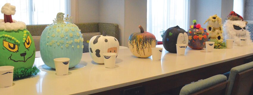 A row of carefully decorated pumpkins sits on display at the Hilton Inn in Paris. Designs ranged in theme from Halloween to Christmas and from recognizable characters to abstract designs.