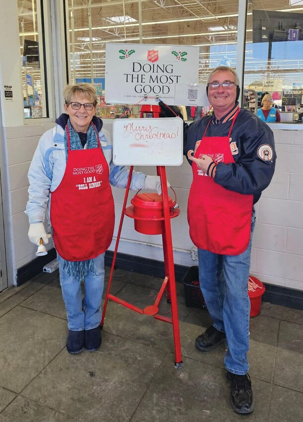 Sue Waltz (left) and Wayne Waltz (right) took a turn ringing the bells at the entrance to the Paris Walmart.