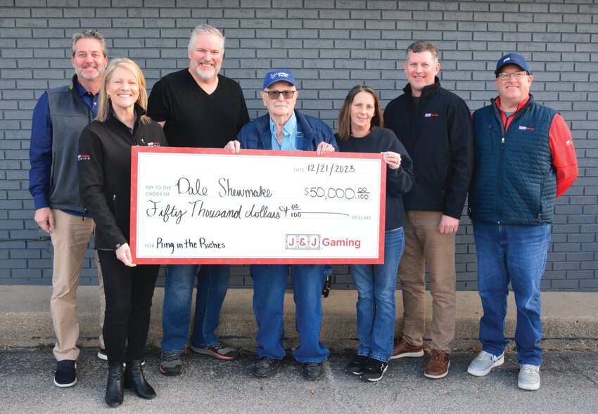 Representatives from J&amp;J Ventures presented a $50,000 check to Dale Shewmake of Paris on Thursday, Dec. 21 as part of J&amp;J&rsquo;s &ldquo;Ring in the Riches&rdquo; sweepstakes. Pictured from left to right, Scott Totty, Pam Hemmen, Ben Lueken, owner of R&amp;J Store, Shewmake, Bridget Dahlin, Cary Harper and Brett Gregory.