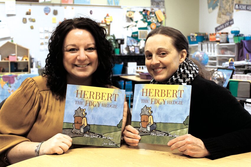 Friends and co-author&rsquo;s Marie Wimsett, left, and Tara Elmore, right, each hold a copy of their  book &ldquo;Herbert the Edgy Hedgy&rdquo; that is available for purchase on Amazon. The authors will travel to Jamaica to collaborate with the Peace Corps and its literacy program.