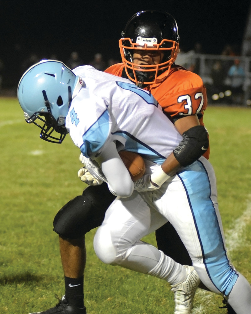 FIGHTING THROUGH: Cesar Mendez looks to break a tackle during Johnston&acirc;&euro;&trade;s game against West Warwick. Mendez and the Panthers held a 20-13 lead at halftime against Division I Cranston West on Friday, before the Falcons outscored Johnston, 29-0, in the second half.