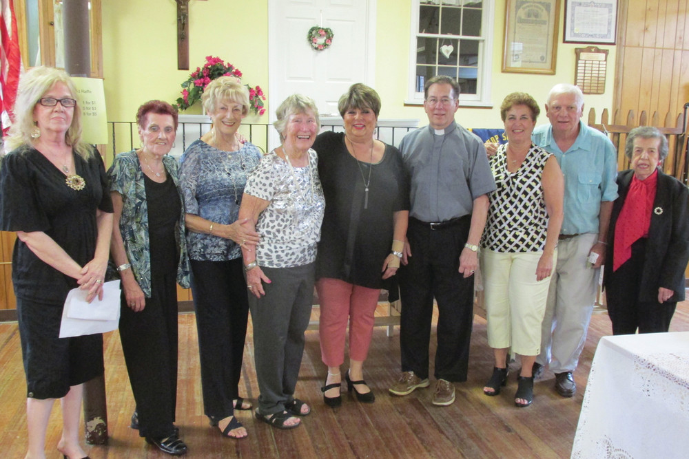 SUPER SUPPORTERS: Some of the parishioners who helped make the Italian Festival a success were Cindy Galipeau, Louisa Iannotti, Doris Haskins, sandy McCarthy, Rose DeLuca, Angela Fillipone, Josephine Gemma, Nadine Corona, and Sandy Cerrito. They are joined here by the Rev. Robert Rochon.