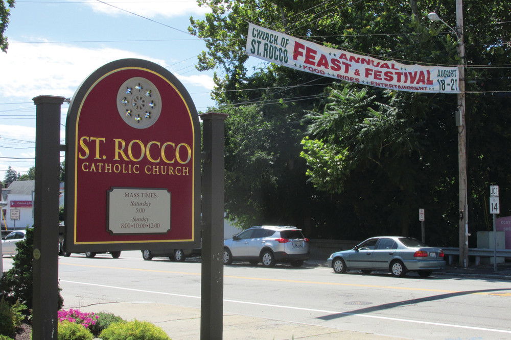 SUPER SIGN: In keeping with tradition, members of St. Rocco&rsquo;s Church fly their annual banner across Atwood Avenue advertising the annual festival that will be held Aug. 18-21.