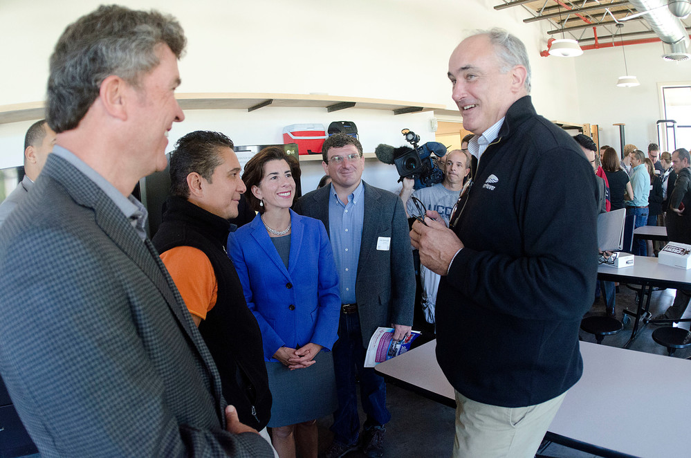 WaterRower owner Peter King (right) gives Governor Gina Raimondo (middle), dignitaries and members of the East Bay Chamber of Commerce a tour of the facility during Manufacturing Day on Friday.