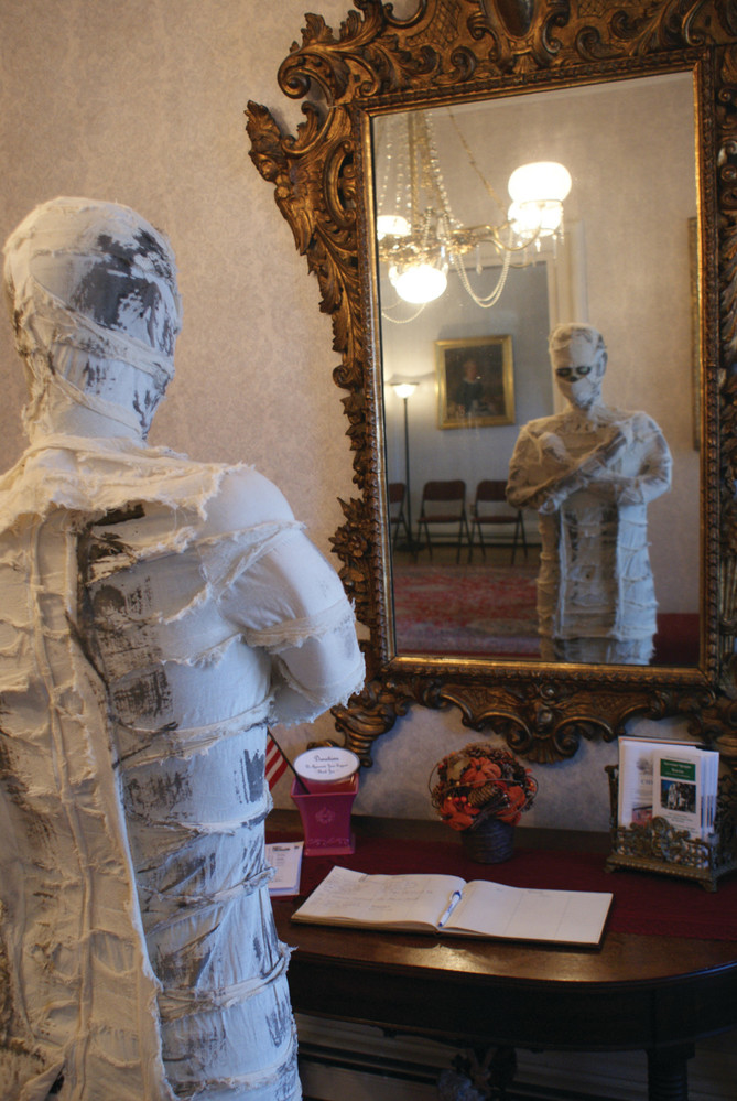 MUMMY IN THE MIRROR: Uncle Wraps is pictured checking on his bandages before the big night.