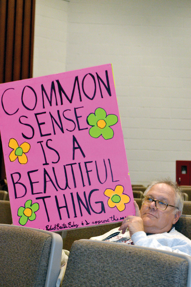 SIGN OF THE TIMES: Bart Balog had a simple message to convey to the committee about school consolidations, and attended the meeting to show his support for Wickes Elementary School.