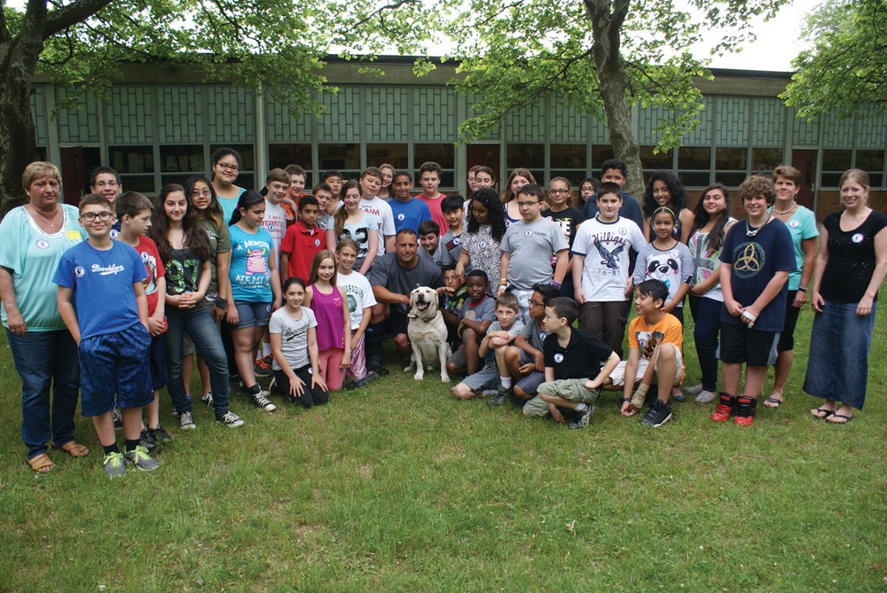 AT EDEN PARK: Pictured are both sixth-grade classes at Eden Park Elementary School in 2014 posing for a photo with Officer Gregg Bruno and K-9 Bosco.
