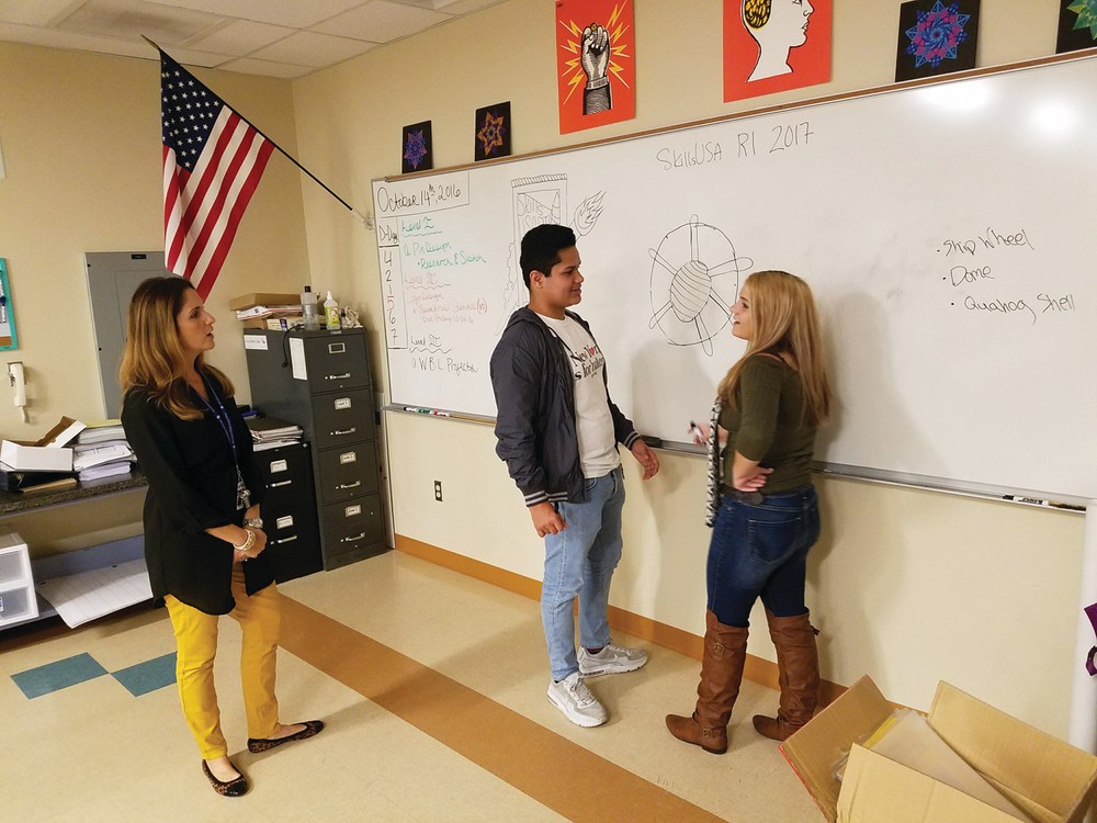 A VALUABLE ADDITION: Regina Hogan is the newest CACTC staff member, and has joined the graphic communications program. Here, she is seen teaching some of her students as they take part in a design challenge to create state pin designs for the SkillsUSA national competition in June.